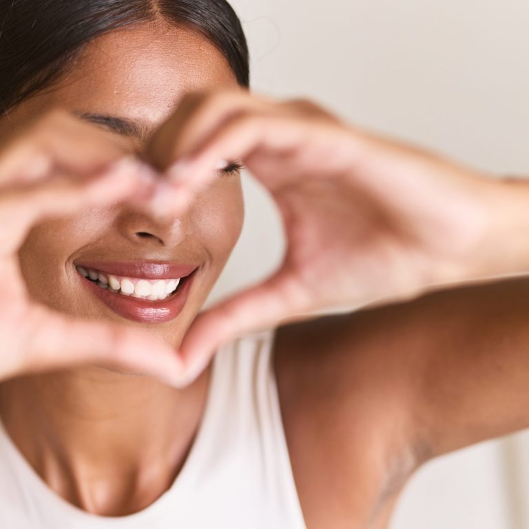 Teeth,Whitening.,Woman,Creating,Heart,Shape,With,Hands,,Radiating,Happiness